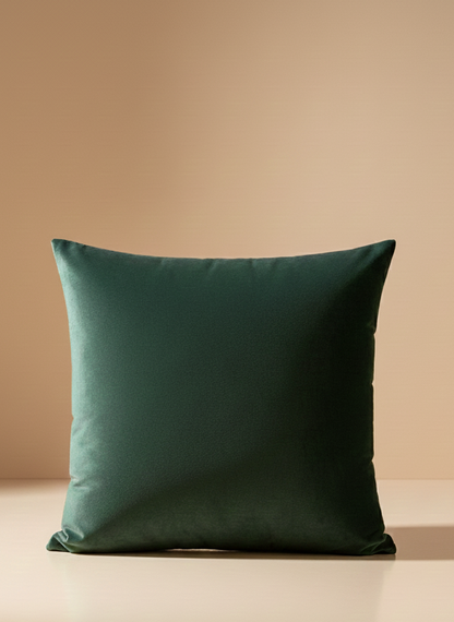 Green pillow on a beige surface with a beige background